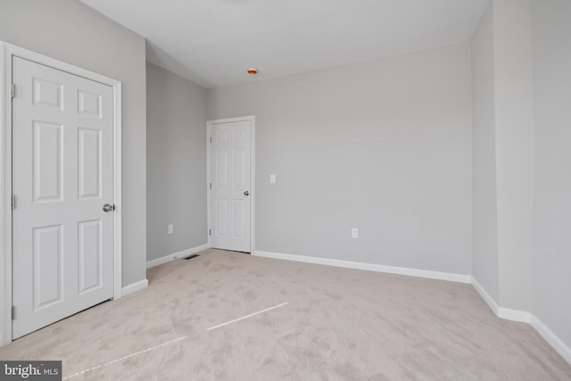 unfurnished bedroom featuring carpet floors and baseboards