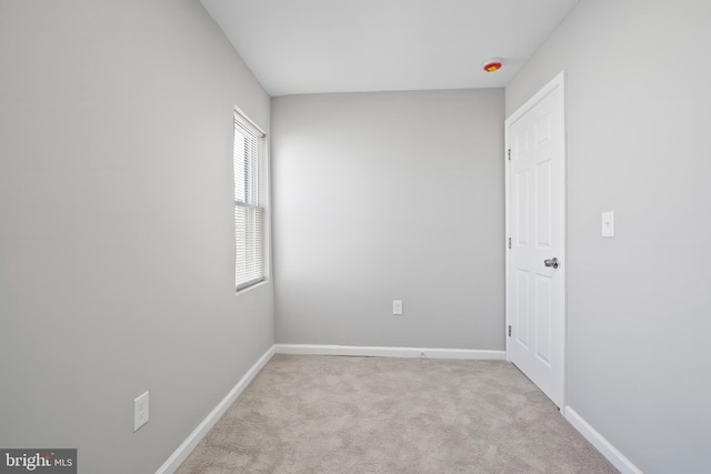 carpeted empty room with baseboards