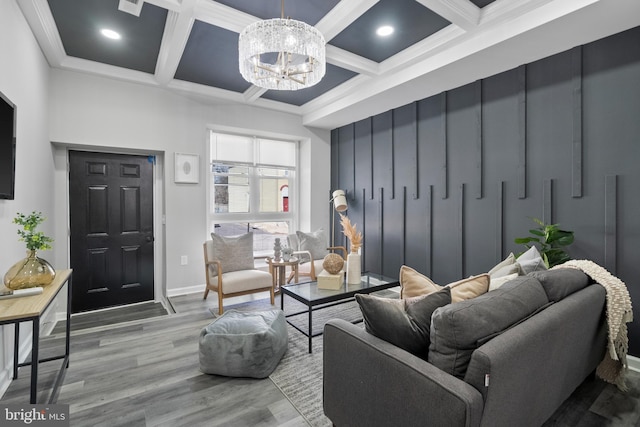 living room with an inviting chandelier, wood finished floors, coffered ceiling, beamed ceiling, and baseboards