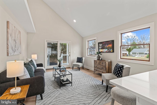 living room featuring recessed lighting, baseboards, high vaulted ceiling, and wood finished floors