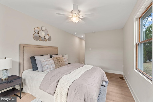 bedroom with visible vents, ceiling fan, baseboards, and wood finished floors