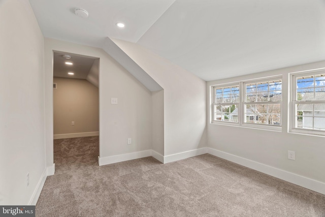 additional living space with recessed lighting, baseboards, and carpet