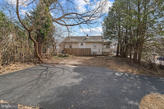 exterior space with fence and a chimney