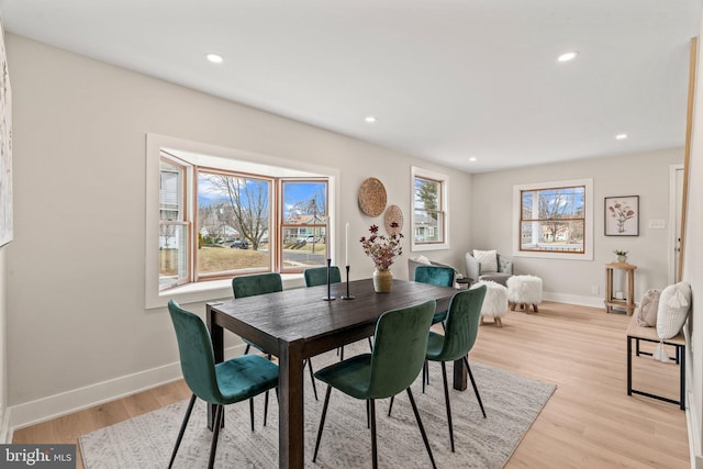 dining space with recessed lighting, baseboards, and light wood finished floors