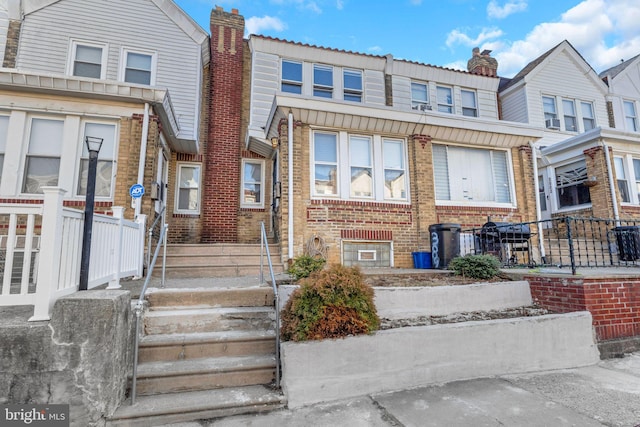 townhome / multi-family property featuring brick siding