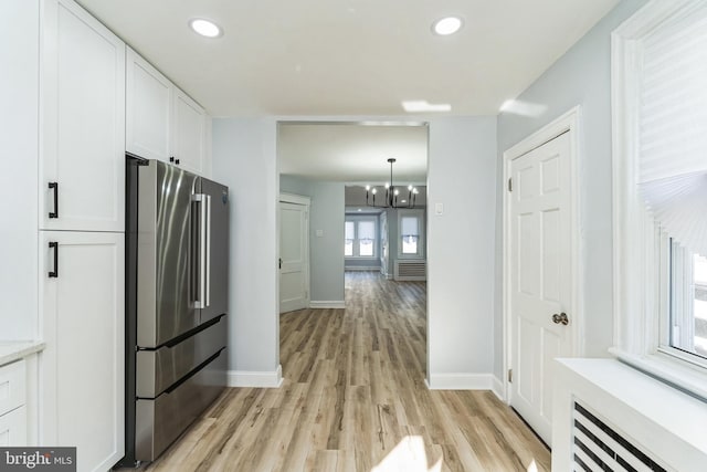 kitchen featuring light countertops, white cabinets, high quality fridge, and recessed lighting