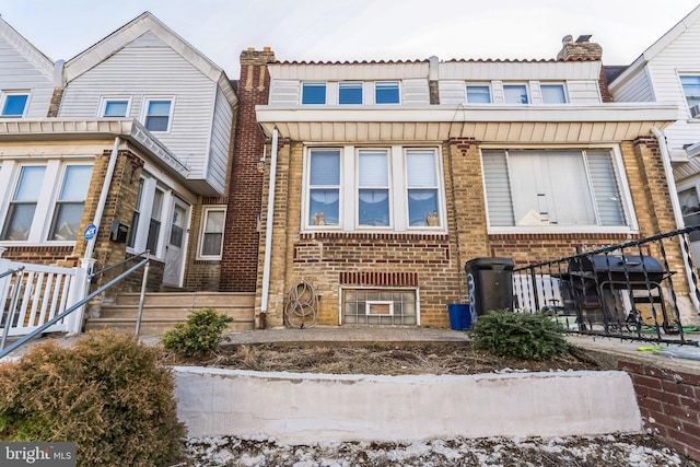 townhome / multi-family property featuring brick siding