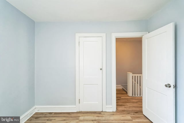 unfurnished room with light wood-style floors and baseboards