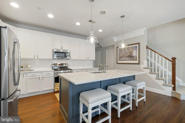 kitchen featuring decorative backsplash, visible vents, stainless steel appliances, and a sink