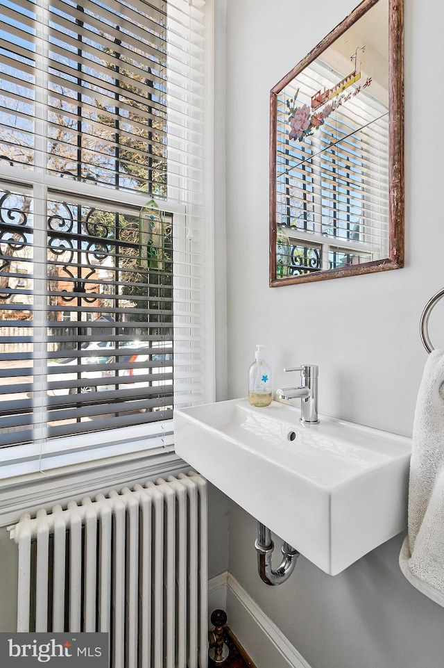 bathroom with plenty of natural light, a sink, and radiator