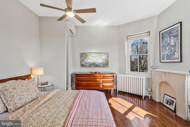 bedroom featuring radiator, wood-type flooring, ceiling fan, and a wall mounted AC