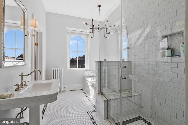 full bath featuring radiator, a stall shower, tile patterned flooring, baseboards, and a bath