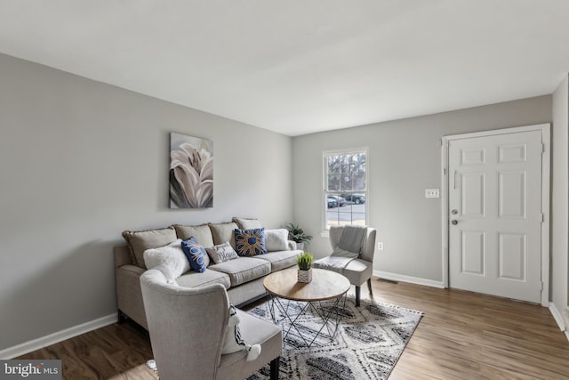 living area featuring wood finished floors and baseboards