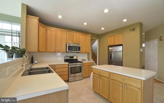 kitchen with visible vents, decorative backsplash, stainless steel appliances, light countertops, and a sink