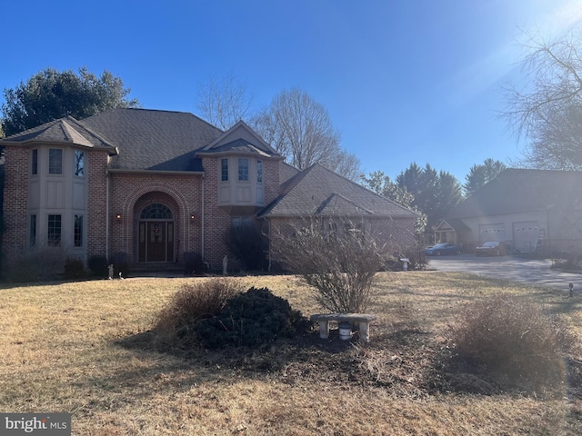 view of front of house featuring a front yard and brick siding