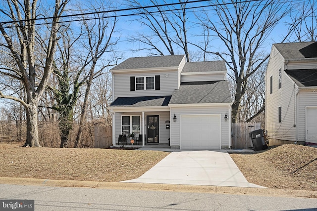 view of front of home with an attached garage, covered porch, driveway, and fence