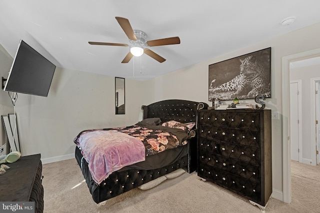 carpeted bedroom featuring a ceiling fan and baseboards