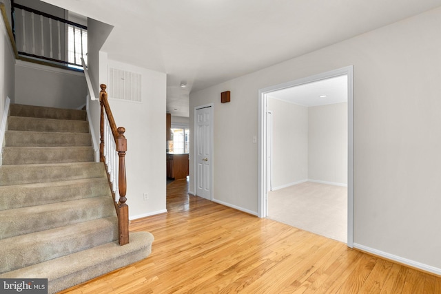 interior space featuring baseboards, visible vents, and wood finished floors