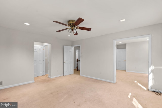 unfurnished bedroom featuring recessed lighting, light carpet, and baseboards