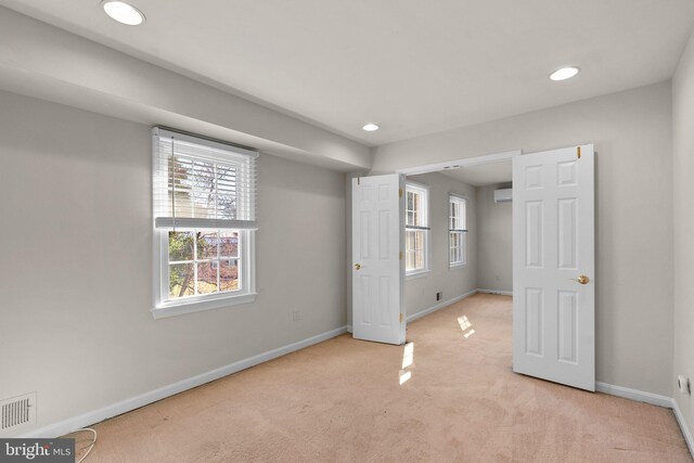 unfurnished bedroom featuring light carpet, recessed lighting, visible vents, and baseboards