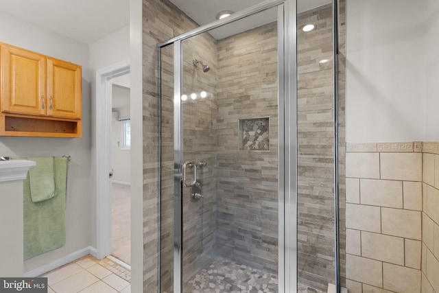 full bath with tile patterned flooring and a shower stall