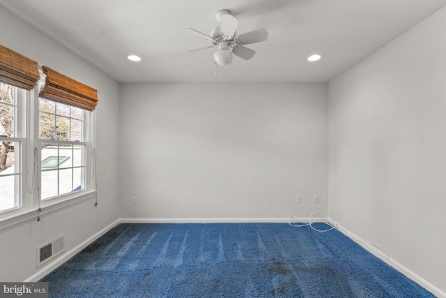 empty room featuring recessed lighting, dark carpet, visible vents, and baseboards