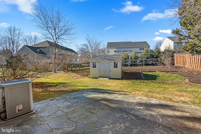 view of patio featuring an outbuilding, fence, and a shed