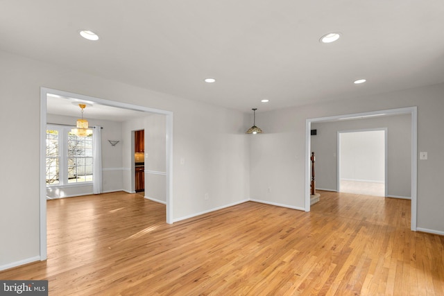 spare room with light wood-style floors, recessed lighting, and baseboards