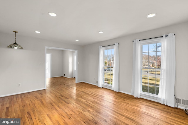 interior space featuring recessed lighting, light wood-style flooring, and baseboards