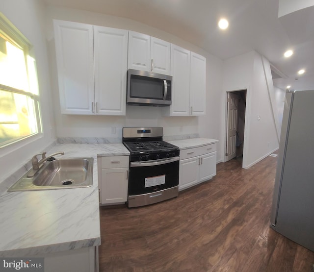 kitchen with white cabinets, stainless steel appliances, and a sink