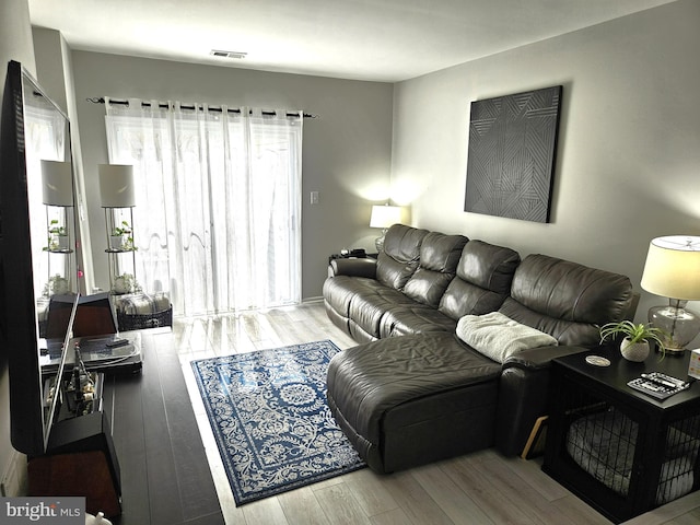 living room with wood finished floors and visible vents