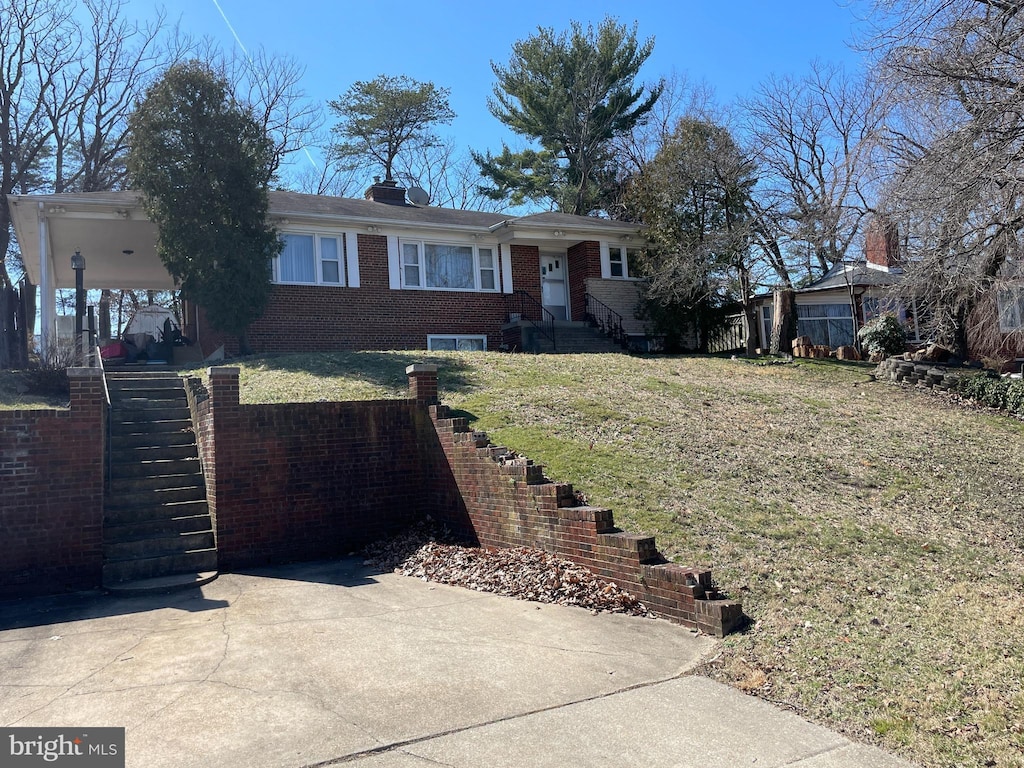 ranch-style house with brick siding and a front lawn