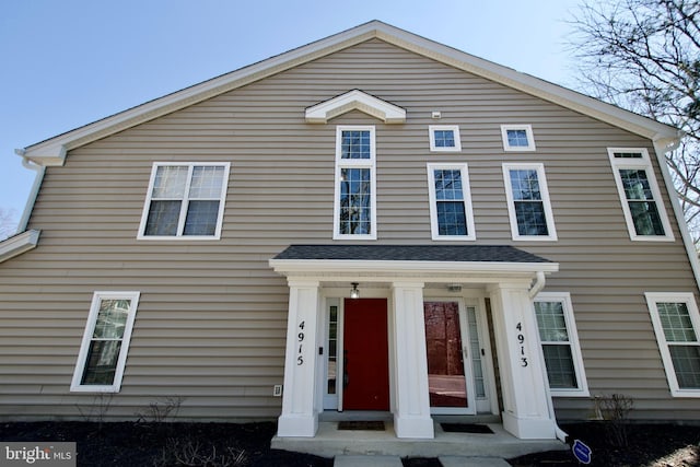 view of front of house with a shingled roof