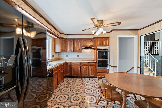 kitchen featuring brown cabinets, crown molding, light countertops, a sink, and black appliances