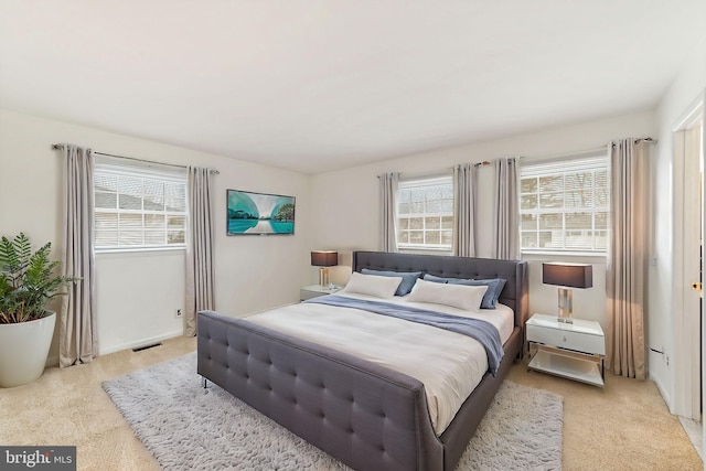 bedroom with light colored carpet and visible vents