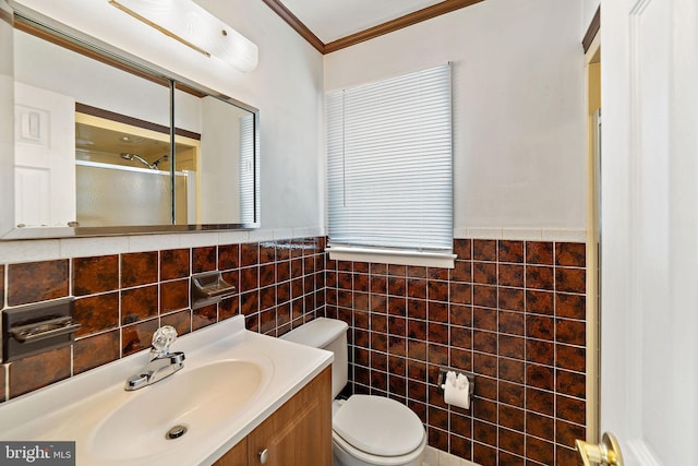 bathroom with tile walls, toilet, an enclosed shower, ornamental molding, and vanity