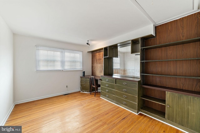 unfurnished bedroom featuring light wood-style floors, visible vents, and baseboards