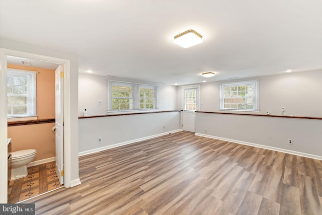 empty room with recessed lighting, baseboards, and wood finished floors