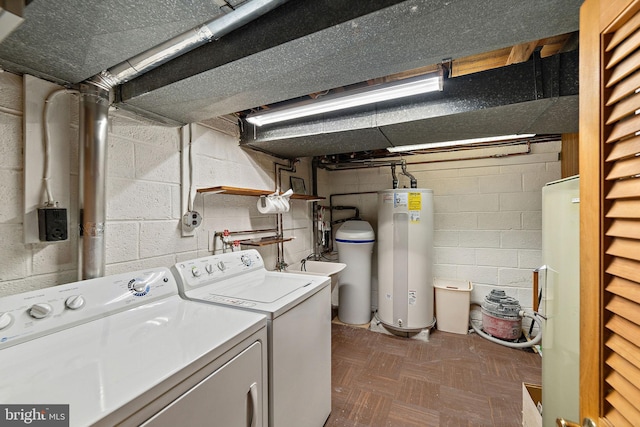 clothes washing area with water heater, laundry area, independent washer and dryer, and a sink