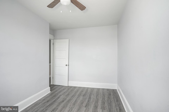 spare room with ceiling fan, baseboards, and wood finished floors