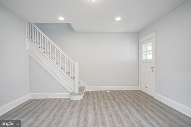 entryway featuring recessed lighting, stairway, baseboards, and wood finished floors