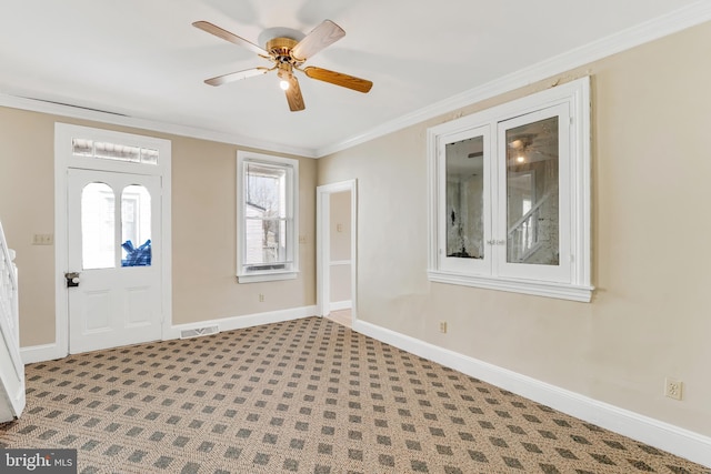 entryway featuring baseboards, visible vents, a ceiling fan, and ornamental molding