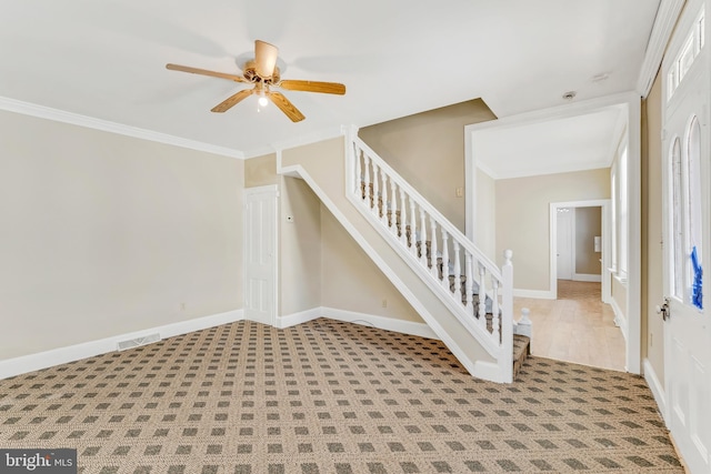 interior space featuring baseboards, visible vents, a ceiling fan, stairway, and crown molding