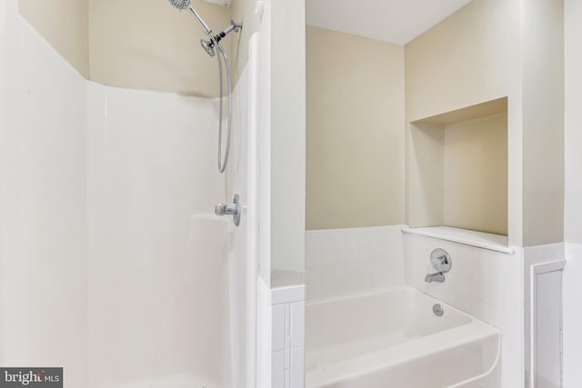 full bathroom featuring walk in shower and a bath