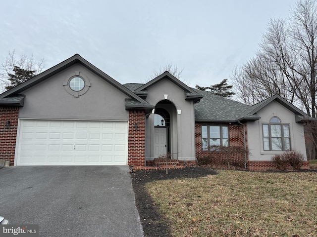 ranch-style house featuring driveway, brick siding, and an attached garage