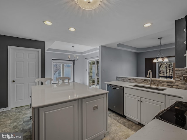 kitchen with a sink, white cabinetry, backsplash, a center island, and dishwasher