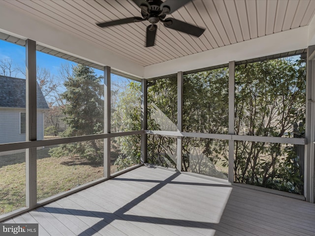 unfurnished sunroom with ceiling fan