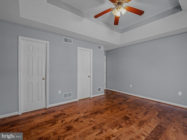 unfurnished bedroom with visible vents and a raised ceiling