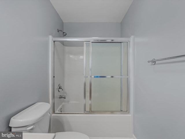 bathroom with shower / bath combination with glass door and toilet