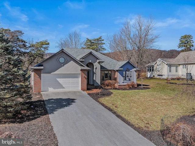 ranch-style home with driveway, a garage, a front lawn, and brick siding